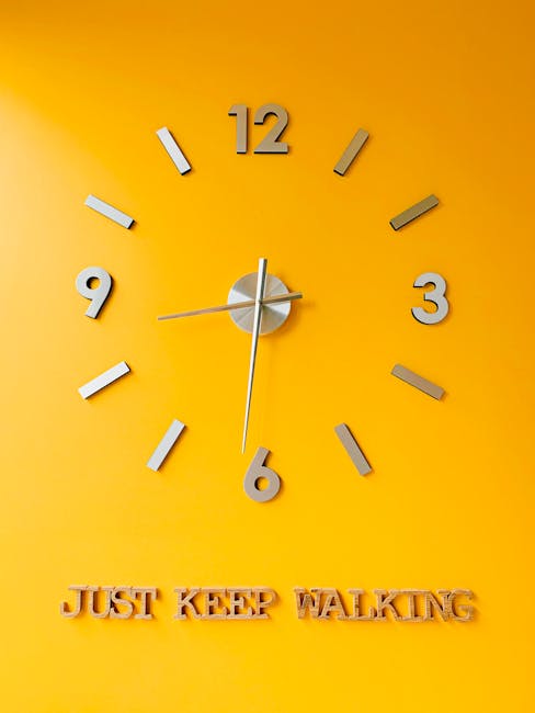 Modern clock on yellow wall